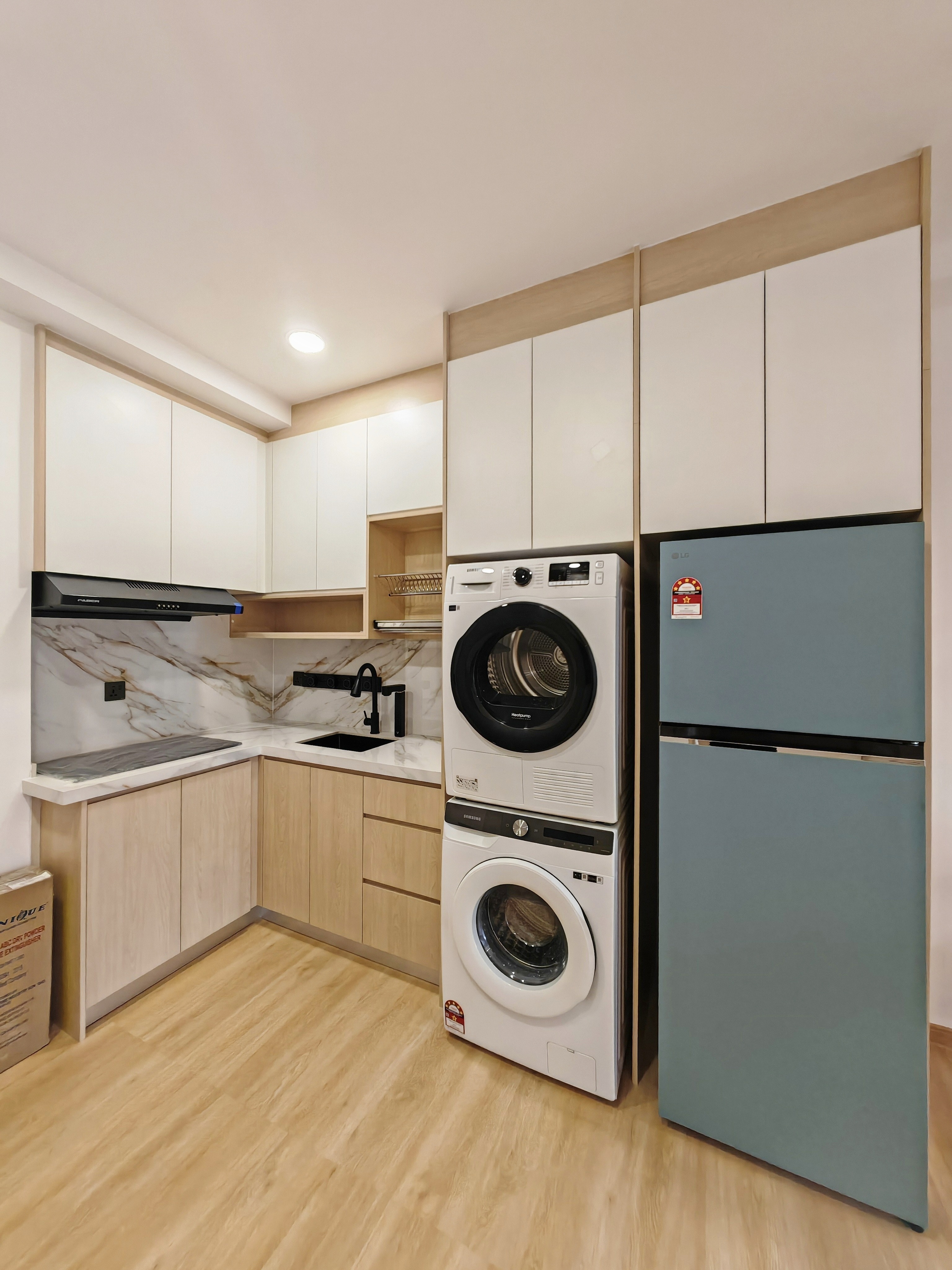 Completed L-shaped kitchen cabinetry with integrated appliances